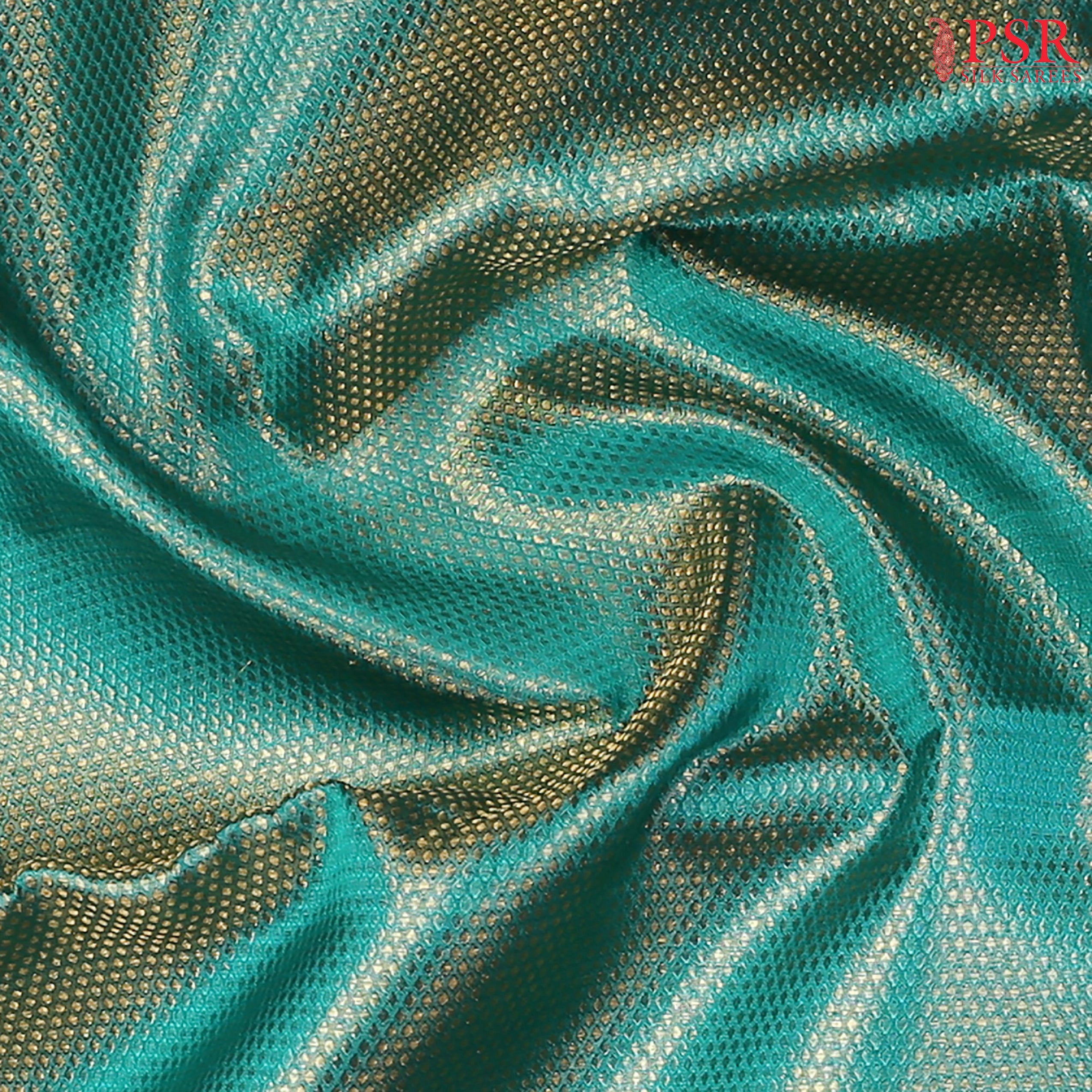 Intricate golden dot motifs enhancing the luxurious silk texture