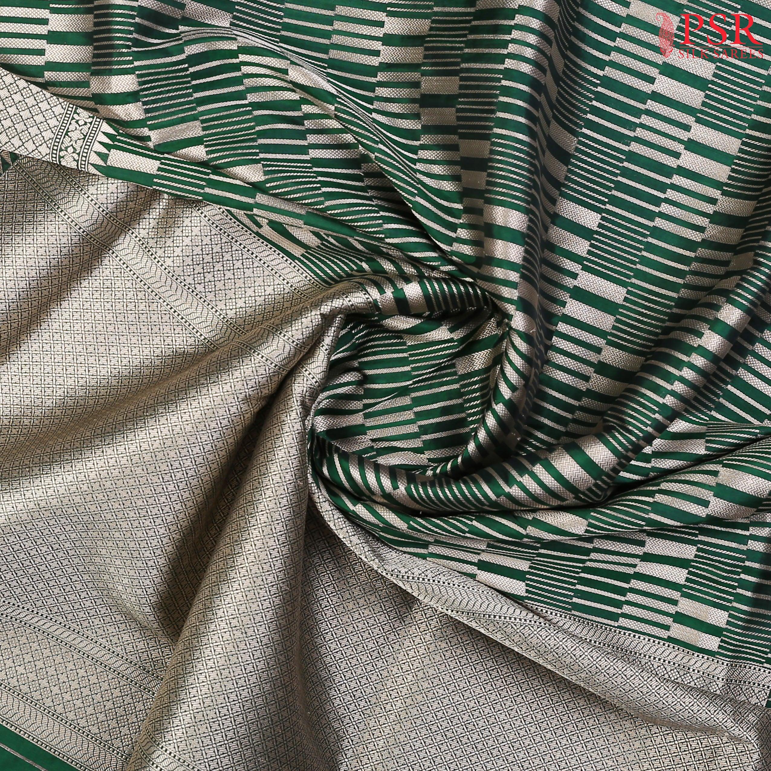 PSR Silk Sarees presents an elegant Dark Green Banaras Silk Saree, a masterpiece of heritage and craftsmanship.