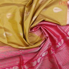 PSR Silk Sarees presents a Flaxen Yellow Soft Tissue Silk Saree, paired beautifully with a Magenta Pink combination.