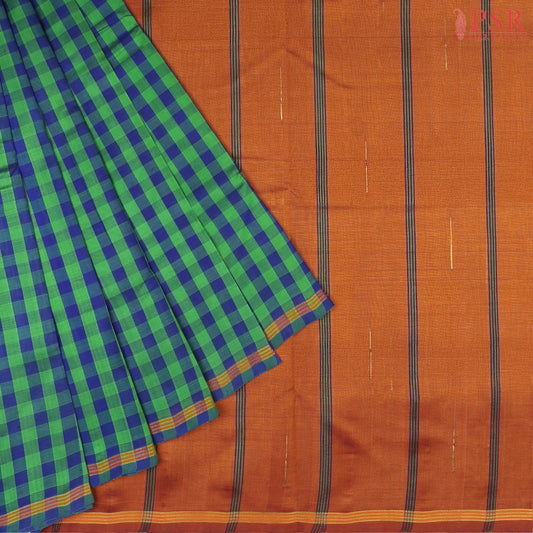 Green & Blue Cotton Silk Saree with checkered pattern, Burnt Orange pallu featuring stripes & Malli Moggu zari motifs, paired with a matching blouse.