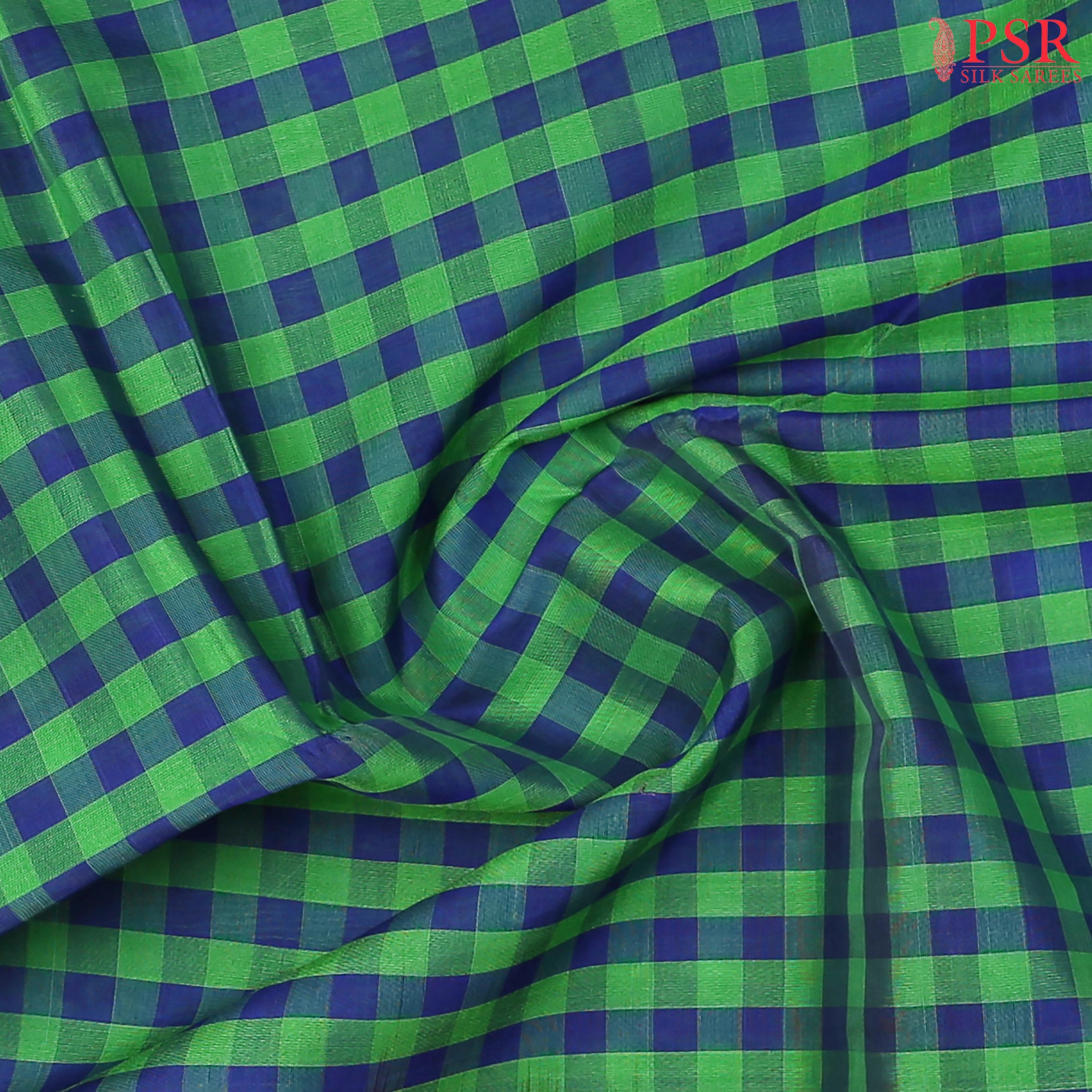 Green & Blue Cotton Silk Saree with checkered pattern, Burnt Orange pallu featuring stripes & Malli Moggu zari motifs, paired with a matching blouse.