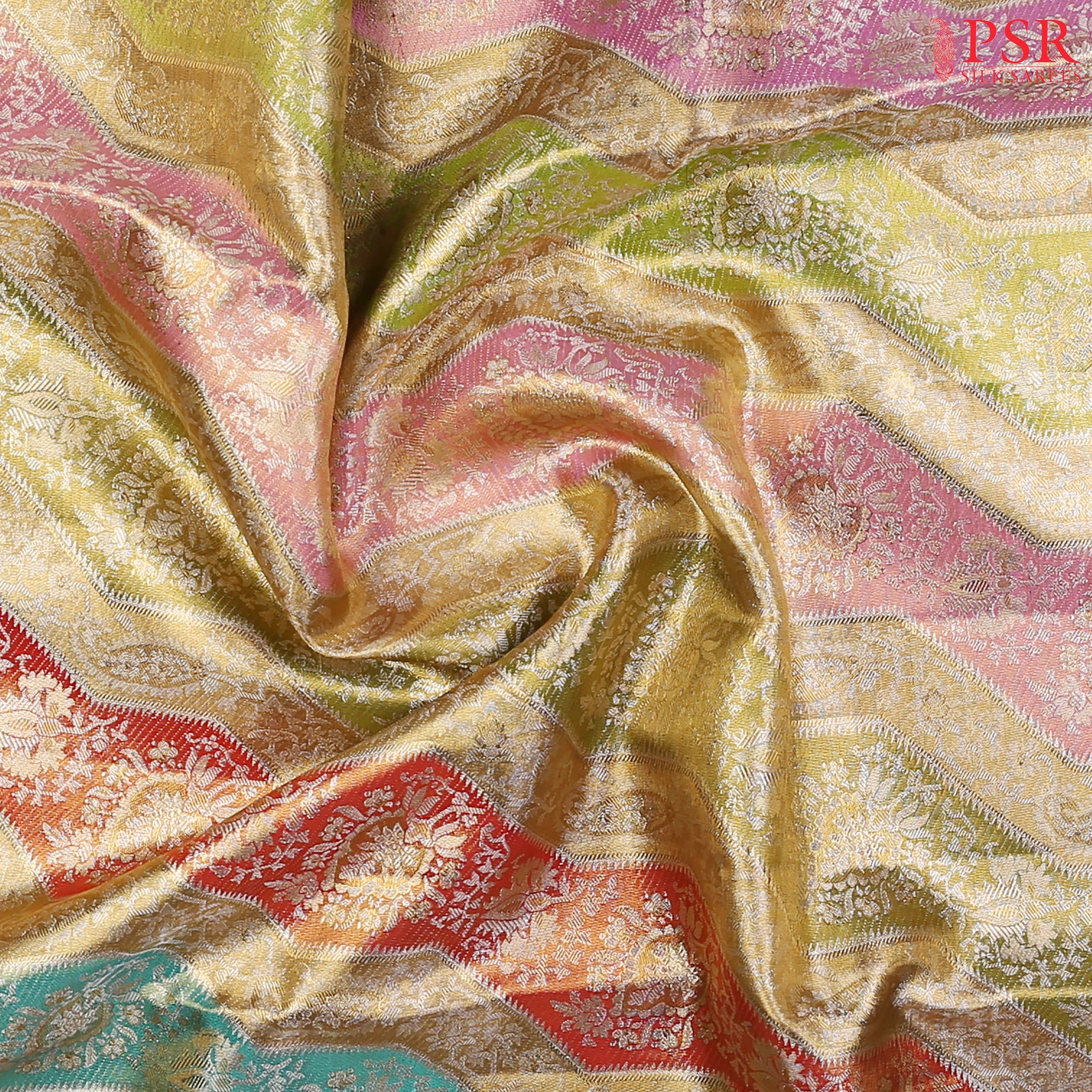Intricate zari detailing with vibrant Pink, Gold, Green, and Turquoise weaves