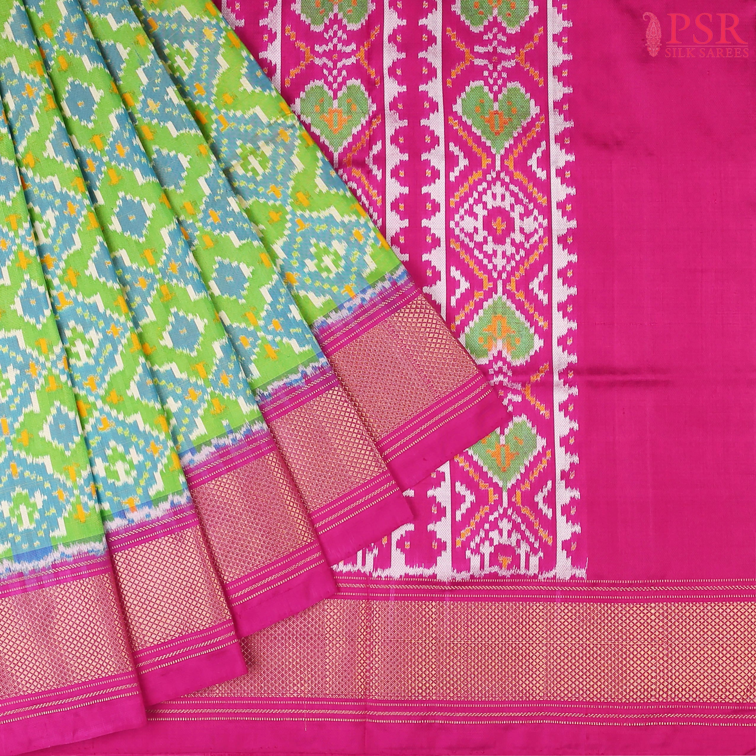 This Parrot Green & Magenta Pink Pochampally Silk Saree from PSR Silk Sarees is a stunning embodiment of heritage and vibrance.