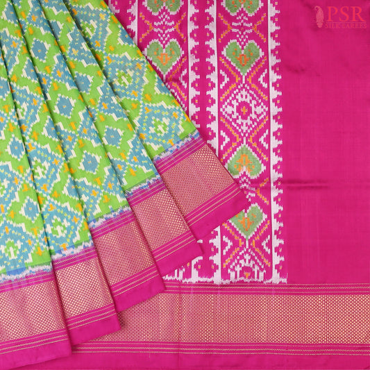 This Parrot Green & Magenta Pink Pochampally Silk Saree from PSR Silk Sarees is a stunning embodiment of heritage and vibrance.
