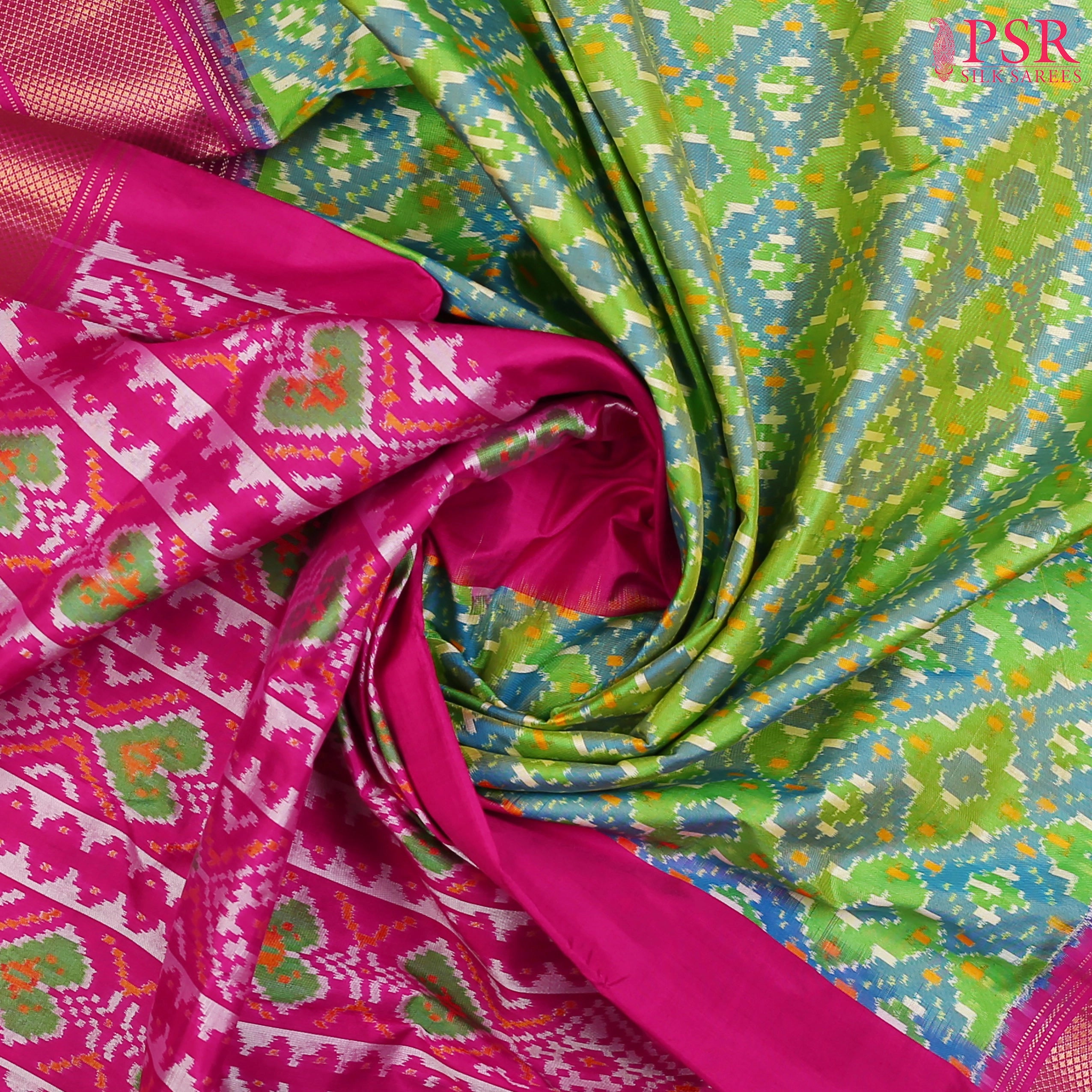 This Parrot Green & Magenta Pink Pochampally Silk Saree from PSR Silk Sarees is a stunning embodiment of heritage and vibrance.
