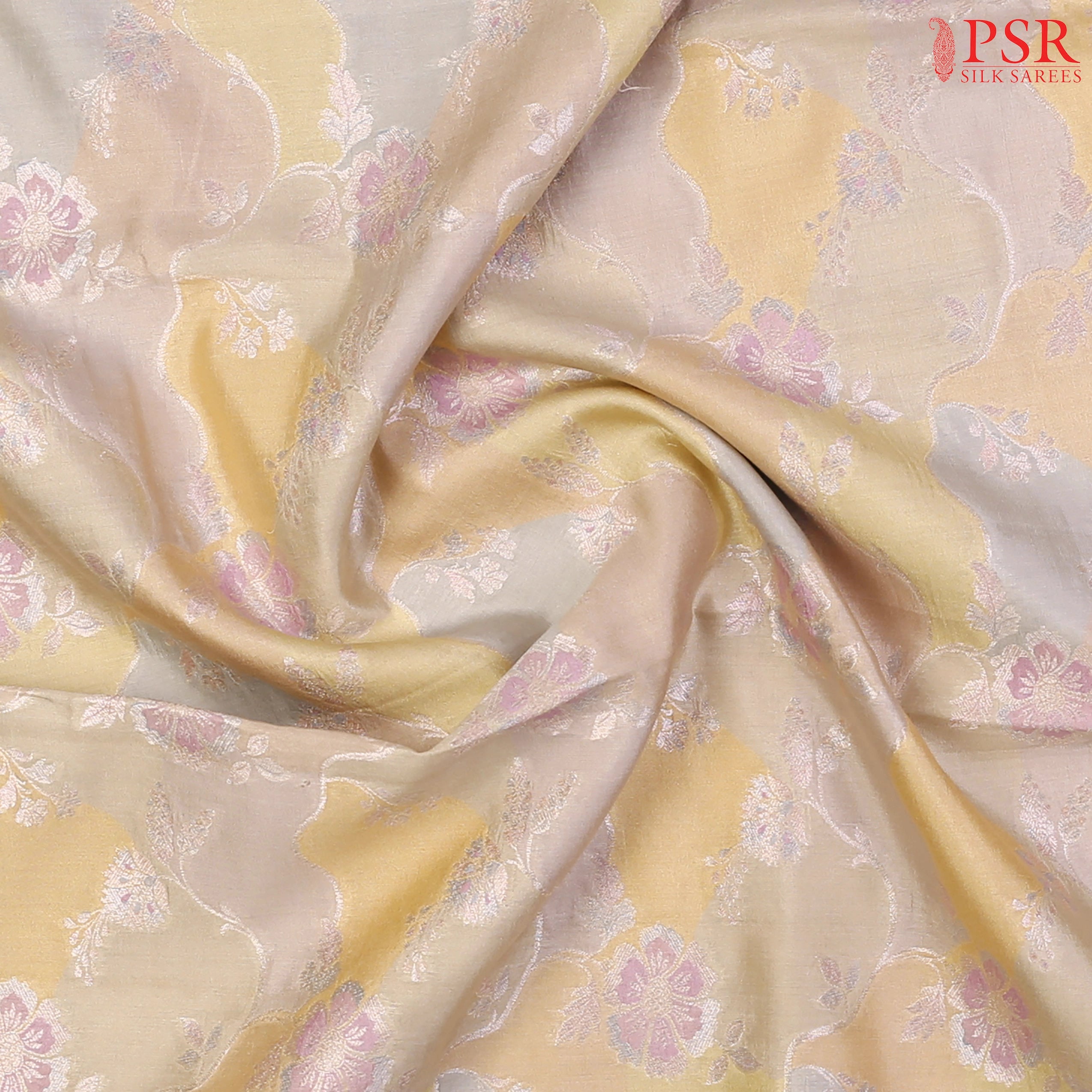 Intricate silver zari and multicolor thread detailing on soft Chiniya silk fabric