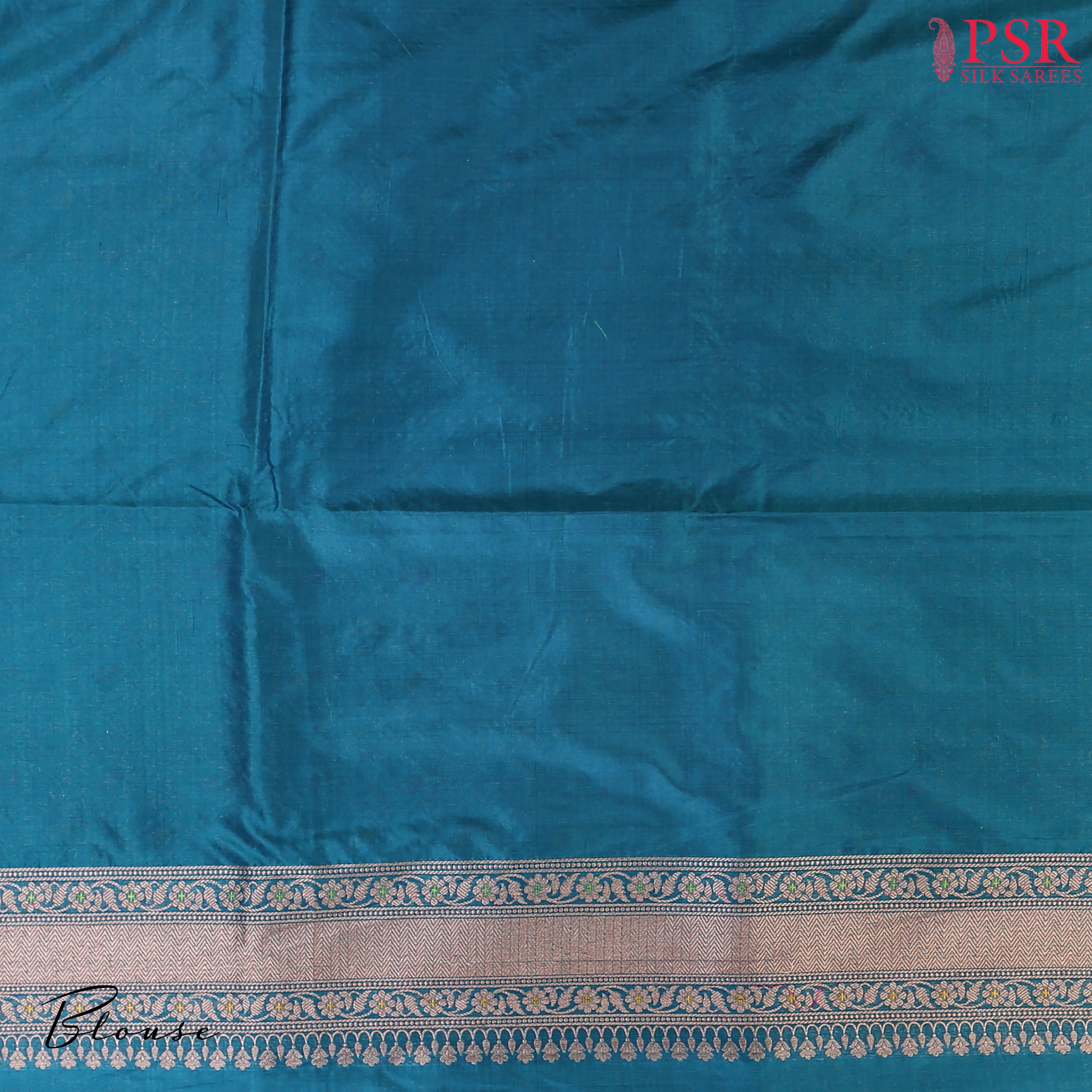 PSR Silks presents a stunning Peacock Blue Banarasi Silk Saree, showcasing a masterfully woven zari lattice pattern, beautifully embellished with vibrant thread work.