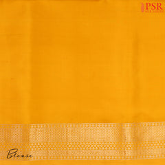 PSR Silk Sarees presents an elegant Amber Yellow Banaras Silk Saree, a masterpiece of heritage and craftsmanship.