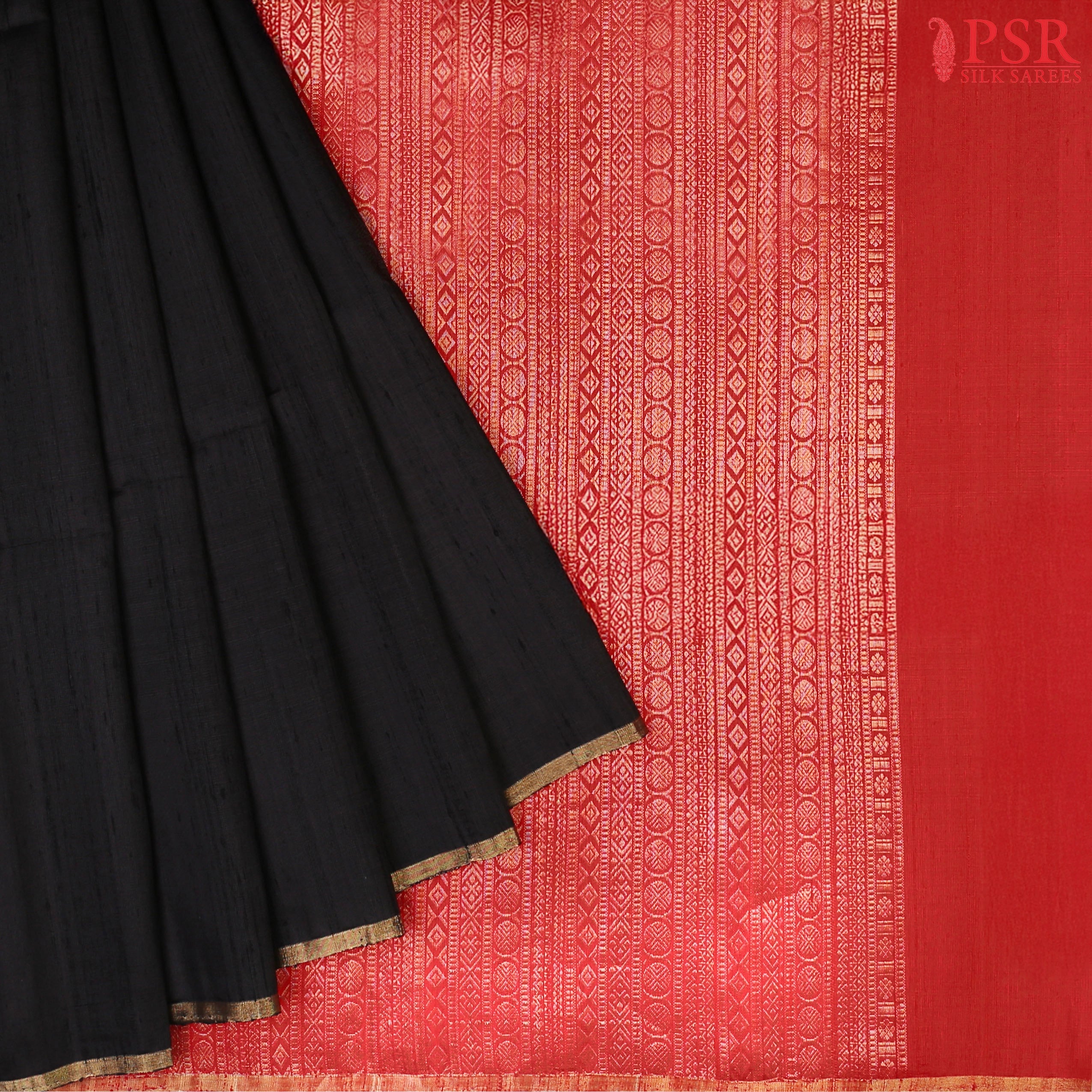 Black Jute Soft Silk Saree with golden zari work, rich Red pallu, and matching designer blouse with zari detailing