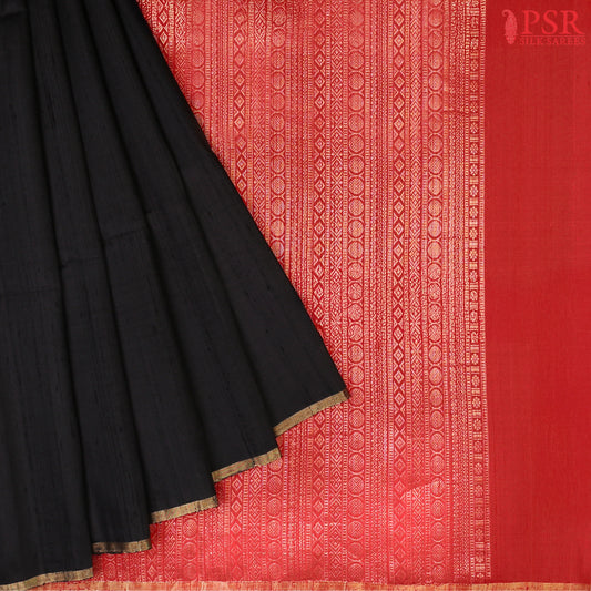 Black Jute Soft Silk Saree with golden zari work, rich Red pallu, and matching designer blouse with zari detailing