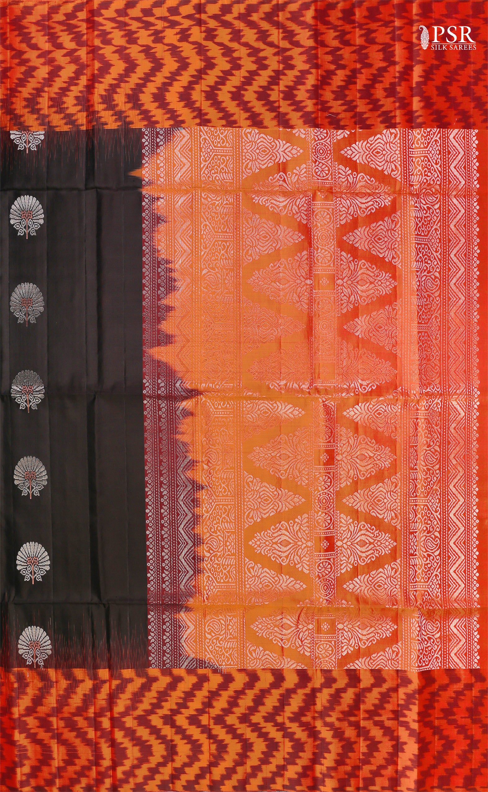 Embrace sophistication with PSR Silks' enchanting Black Soft Silk Saree, perfectly paired with a vibrant Lava Orange combination. This elegant saree is adorned with intricate silver and copper zari floral motifs, radiating timeless beauty.