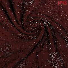 Delicate Bandhini prints enhancing the saree’s crushed silk texture