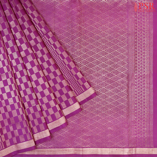 Indulge in timeless elegance with our Byzantium Purple&nbsp;Soft Silk Saree, crafted to perfection with&nbsp;impressive copper zari jacquard geometrical plaids. 