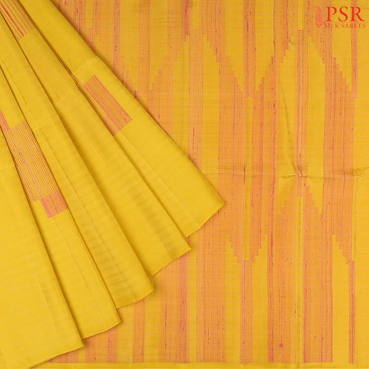 This exquisite Soft Silk saree in a soft Canary Yellow hue is beautifully contrasted with vibrant Flamingo Pink accents