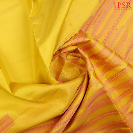 This exquisite Soft Silk saree in a soft Canary Yellow hue is beautifully contrasted with vibrant Flamingo Pink accents
