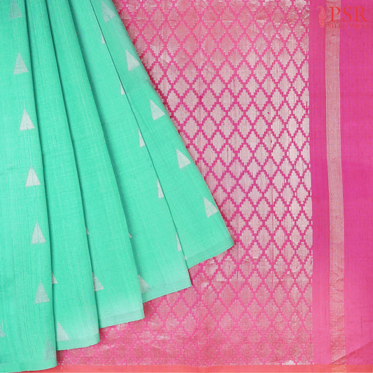 Caribbean Green Jute Soft Silk Saree with silver zari triangle motifs, rich Magenta Pink pallu, and matching plain blouse.