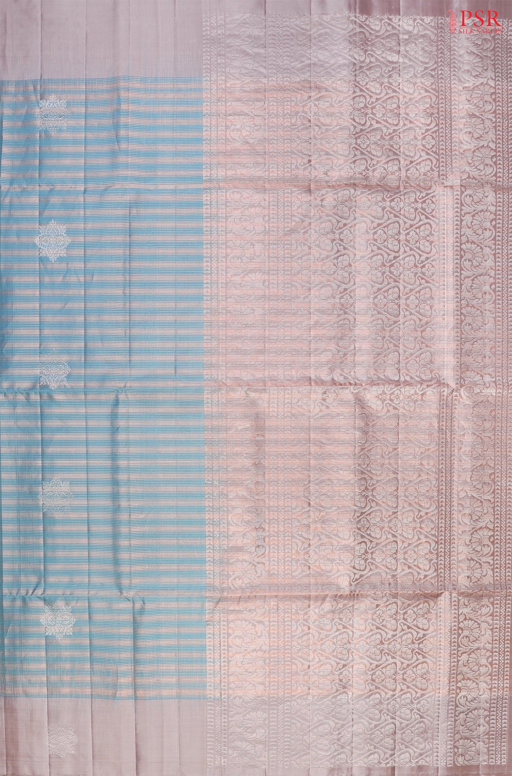 Introducing our Cerulean Blue Soft Silk Saree, an embodiment of elegance and charm. This exquisite saree is adorned with copper zari stripes and delicate silver zari floral motifs, creating a harmonious blend of tradition and modernity.