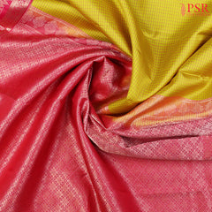 PSR Silks presents a Corn Yellow Fancy Kanchipuram Silk Saree, elegantly paired with a striking Magenta Pink combination. A timeless blend of tradition and grace