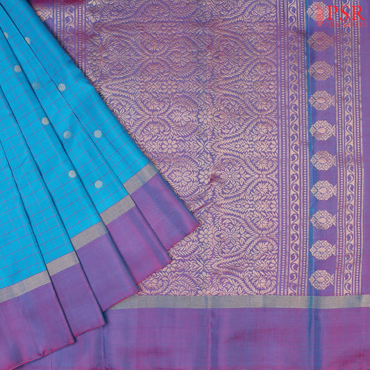Step into regal sophistication with our Cyan Soft Silk Saree, exquisitely paired with a rich Purple contrast. 