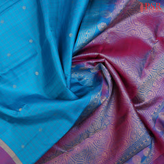 Step into regal sophistication with our Cyan Soft Silk Saree, exquisitely paired with a rich Purple contrast. 