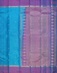 Step into regal sophistication with our Cyan Soft Silk Saree, exquisitely paired with a rich Purple contrast. 