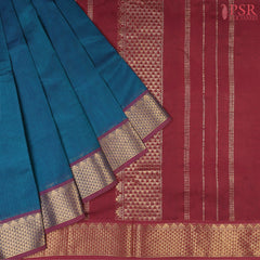 Dark Peacock Blue Cotton Silk Saree with a Maroon zari chit pallu, zari border, and plain Maroon blouse. A timeless and elegant traditional wear.