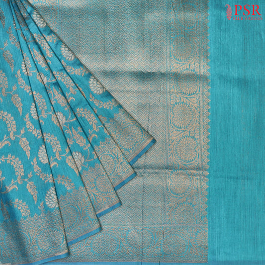PSR Silks introduces a stunning Dark Turquoise Banarasi Jute Silk saree, perfect for making a statement.
