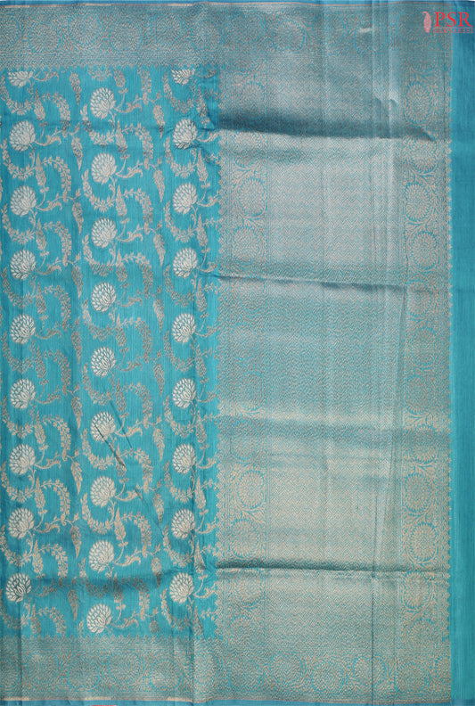 PSR Silks introduces a stunning Dark Turquoise Banarasi Jute Silk saree, perfect for making a statement.