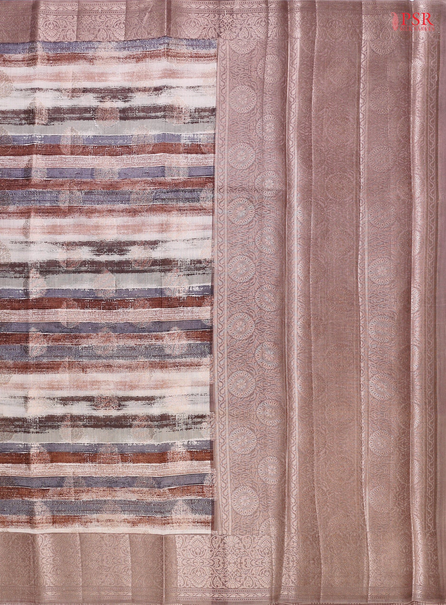 Presenting a Soft Chiniya Silk Saree in a graceful Dusty Mauve hue, designed to captivate and charm. This exquisite saree features brush stripes complemented by intricate zari brocade motifs, adding a modern twist to traditional beauty.