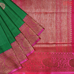 PSR Silks presents a majestic Emerald Green Banarasi Silk Saree, elegantly complemented by a vibrant Magenta hue.