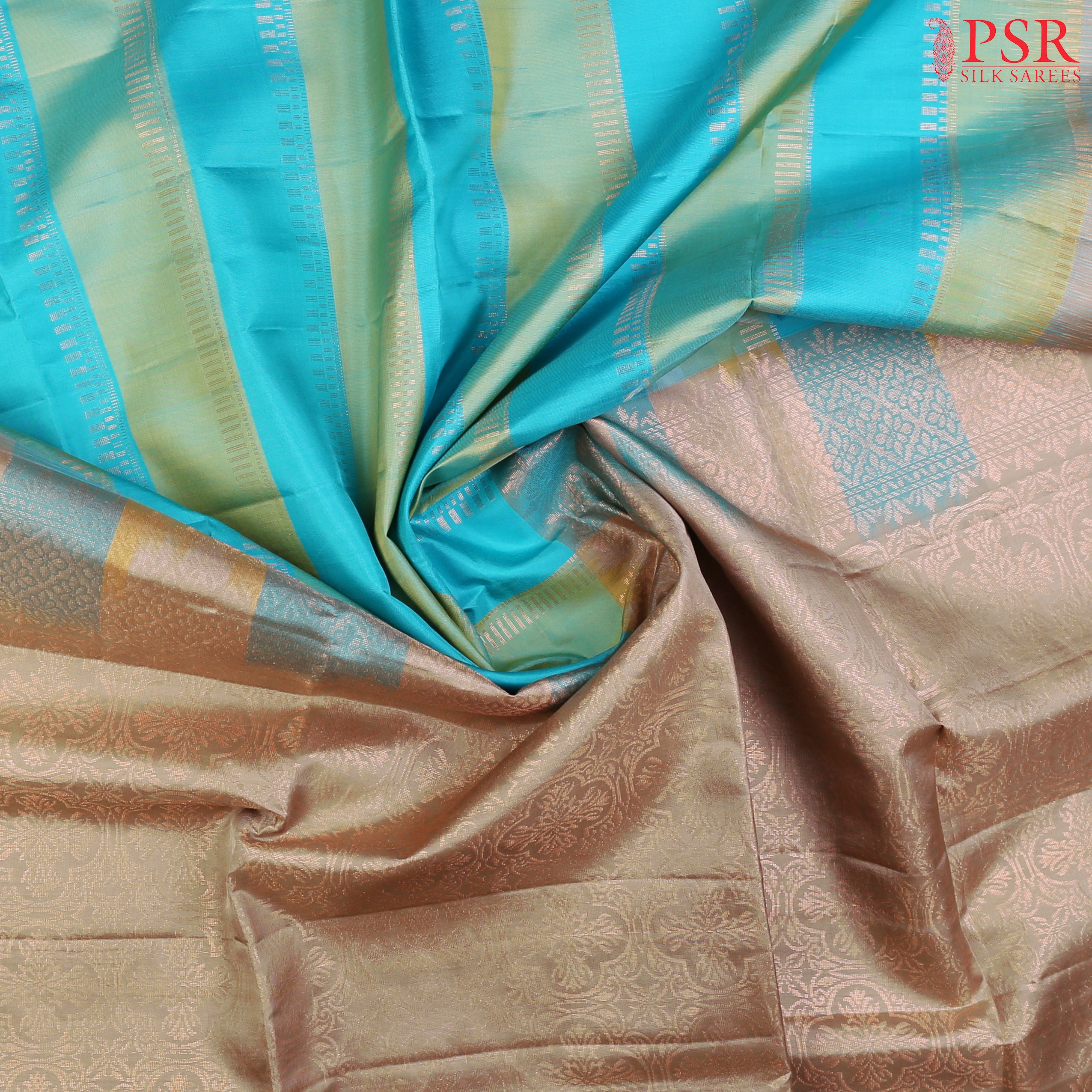 PSR Silk Sarees presents a graceful Light Blue and Light Green Soft Silk Saree, beautifully paired with a sophisticated Olive Grey accent. This saree stands out with its&nbsp;double-colored stripes, delicately woven with lustrous copper zari work, adding a touch of modern elegance.
