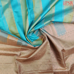 PSR Silk Sarees presents a graceful Light Blue and Light Green Soft Silk Saree, beautifully paired with a sophisticated Olive Grey accent. This saree stands out with its&nbsp;double-colored stripes, delicately woven with lustrous copper zari work, adding a touch of modern elegance.