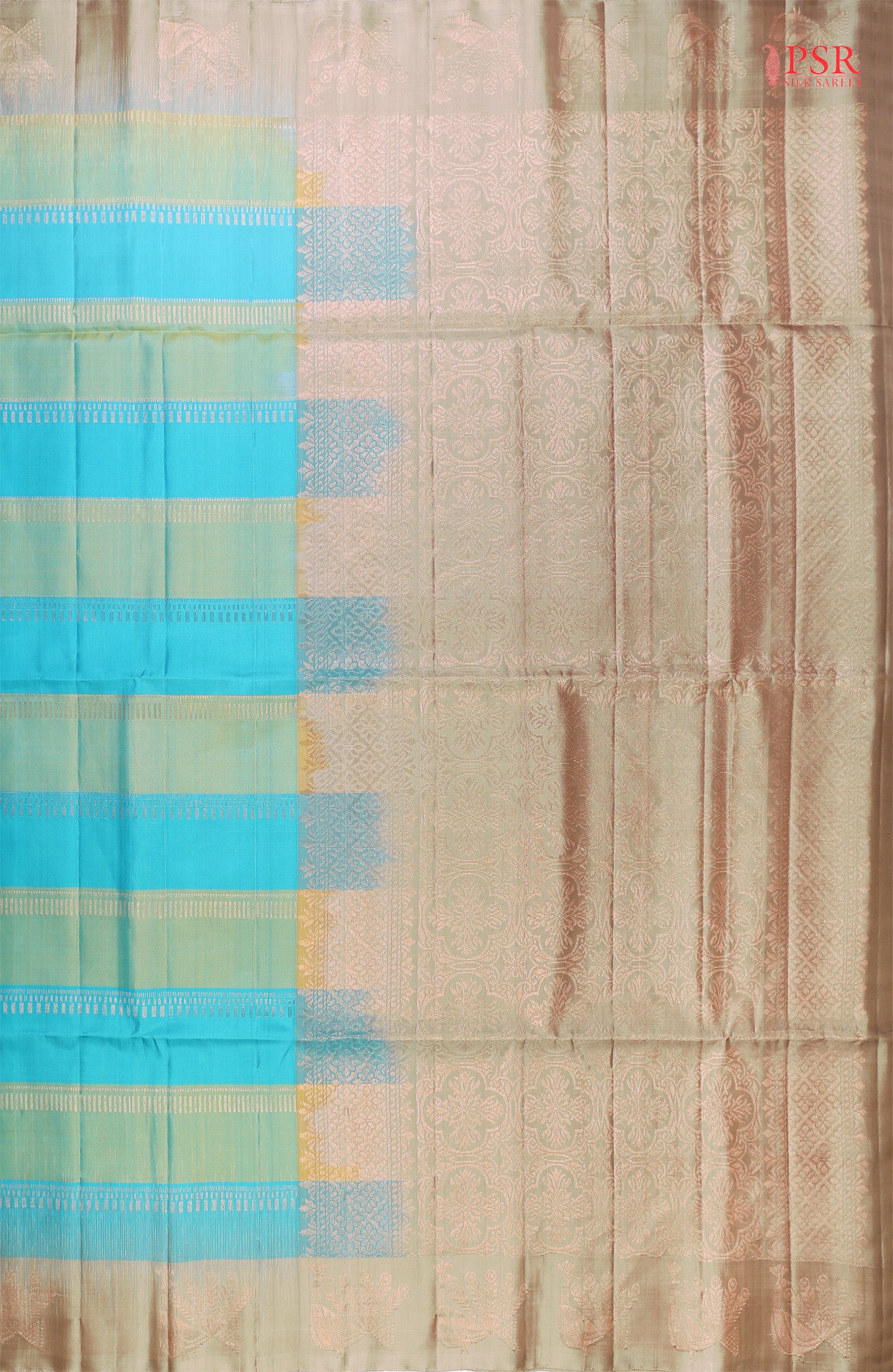 PSR Silk Sarees presents a graceful Light Blue and Light Green Soft Silk Saree, beautifully paired with a sophisticated Olive Grey accent. This saree stands out with its&nbsp;double-colored stripes, delicately woven with lustrous copper zari work, adding a touch of modern elegance.