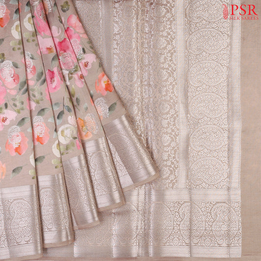 Mink Grey Chiniya Silk Saree with vibrant floral prints and silver zari paisley motifs.