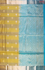 Discover the charm of tradition with a modern twist in PSR Silks' Olive Yellow Soft Silk Saree, beautifully paired with a vibrant Bright Cerulean Blue.