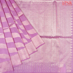 Introducing our Orchid Purple Soft Silk Saree, a stunning fusion of rich tradition and modern sophistication. This elegant saree features toned copper zari curvy tissue stripes, creating a captivating and luxurious texture that stands out in every light.