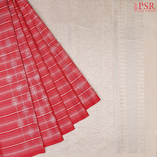 Unveil the beauty of our Pepper Red Soft Silk Saree, perfectly paired with a contrasting Gainsboro Grey combination. This stylish borderless saree features exquisite tissue barcode stripes beautifully adorned with blue and copper zari work, adding texture and sophistication.