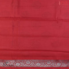 Red Chiniya Silk Saree, a timeless masterpiece adorned with silver zari floral brocade motifs. 