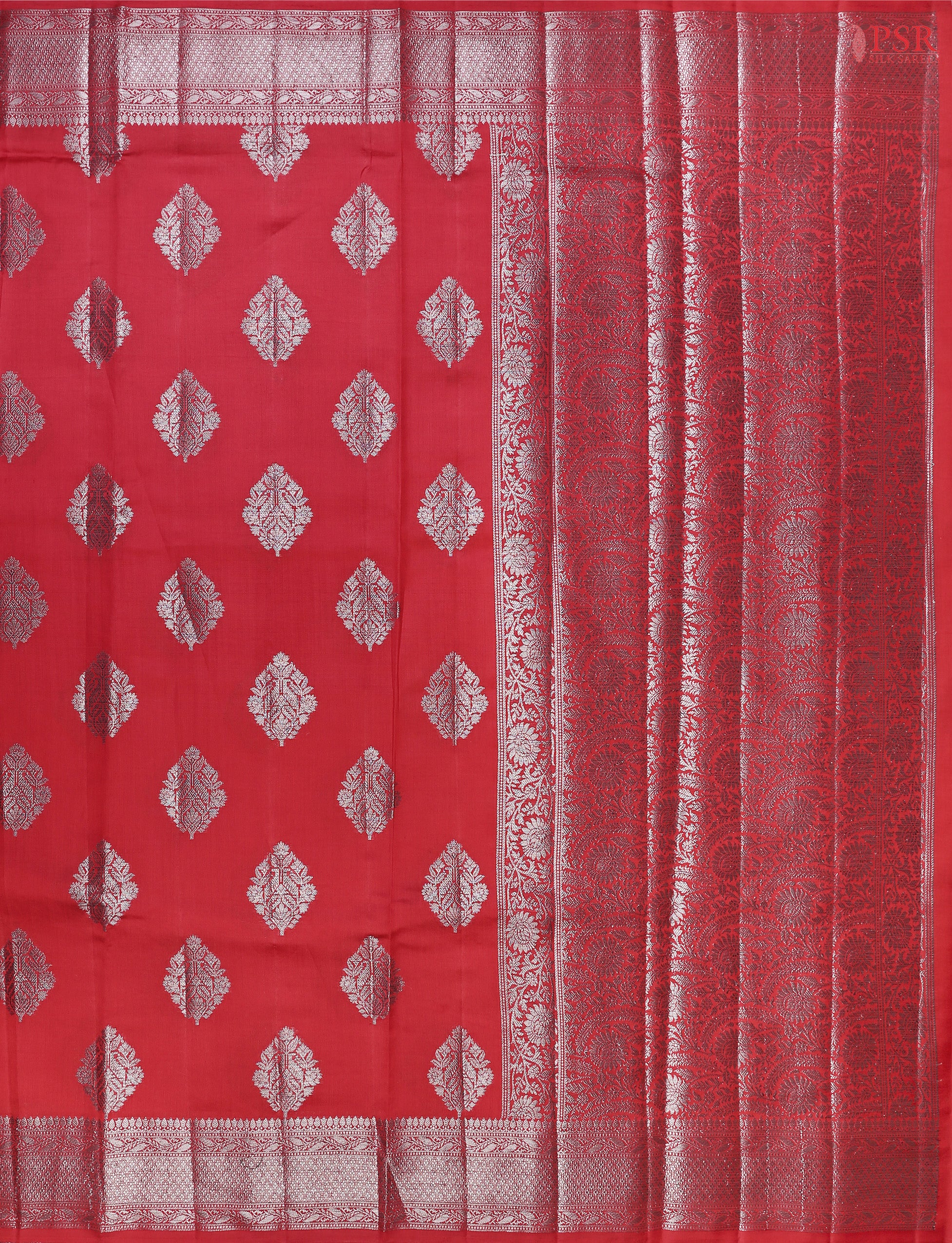 Red Chiniya Silk Saree, a timeless masterpiece adorned with silver zari floral brocade motifs. 
