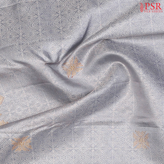 Intricate silver zari jacquard work enhancing the silk fabric