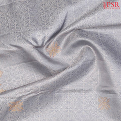 Intricate silver zari jacquard work enhancing the silk fabric