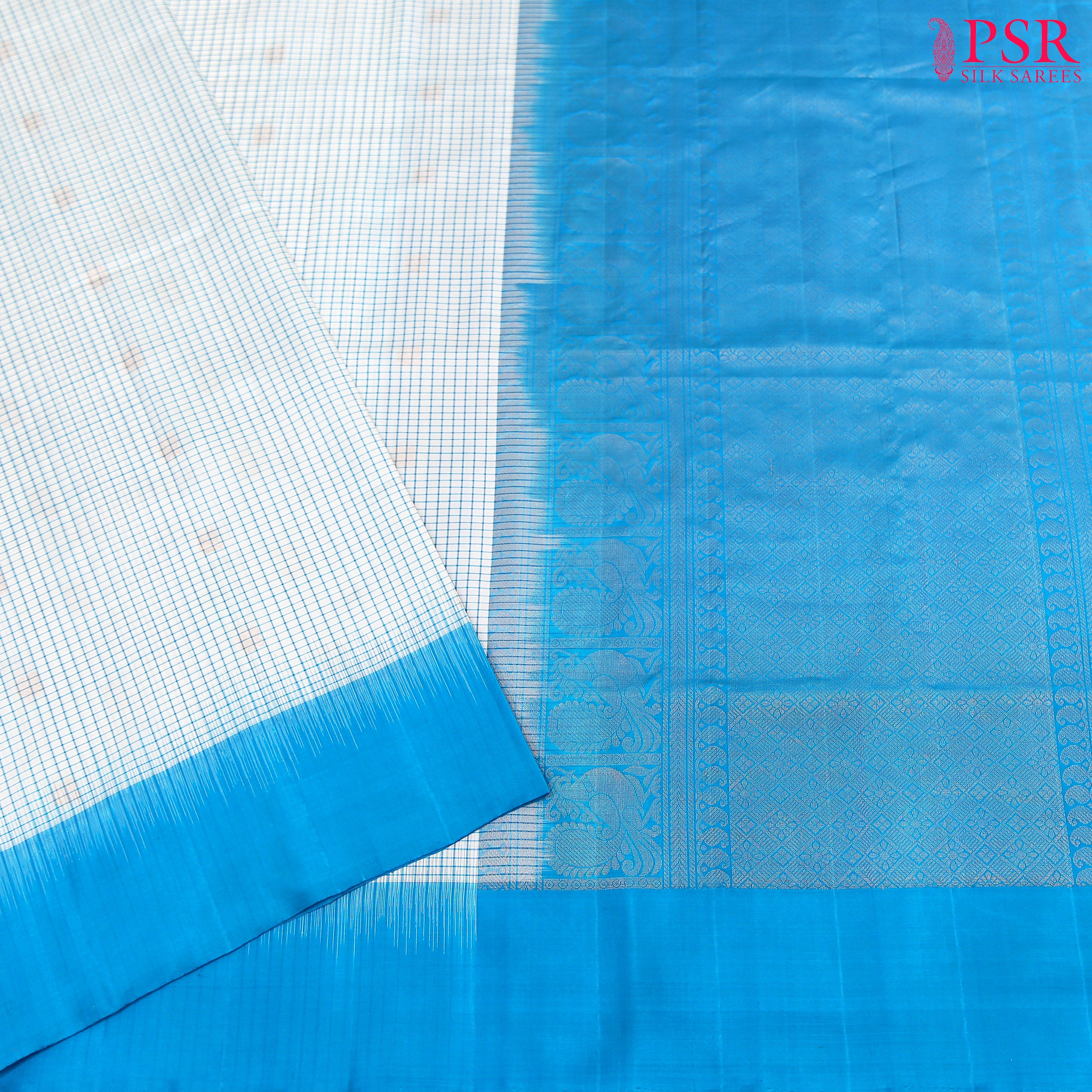 Experience elegance and grace with the exquisite White and Cerulean Blue Coimbatore Soft Silk Saree by PSR Silks. 