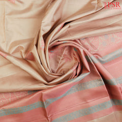 This exquisite Soft Silk saree in a soft Tussar Beige hue is beautifully contrasted with vibrant Punch Pink accents. Featuring intricate floral thread motifs woven into the fabric, this saree is a celebration of artistry and craftsmanship.