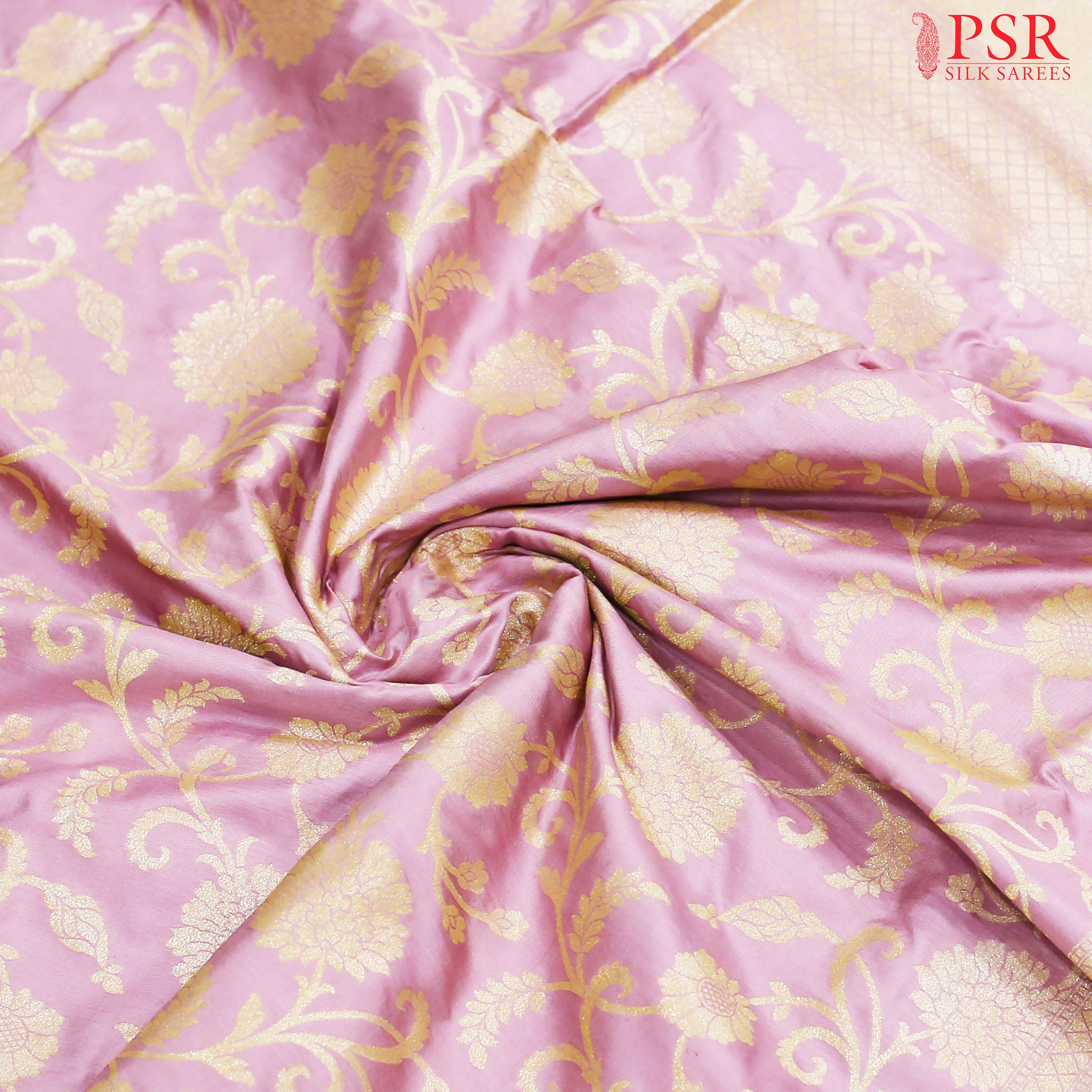 Pastel Taffy Pink Colored Banaras Silk Saree With Beautiful Neem Zari Work. The Scroll Floral Brocade Pattern And Rich Zari Work In Pallu Gives This Saree An Adorable Look.